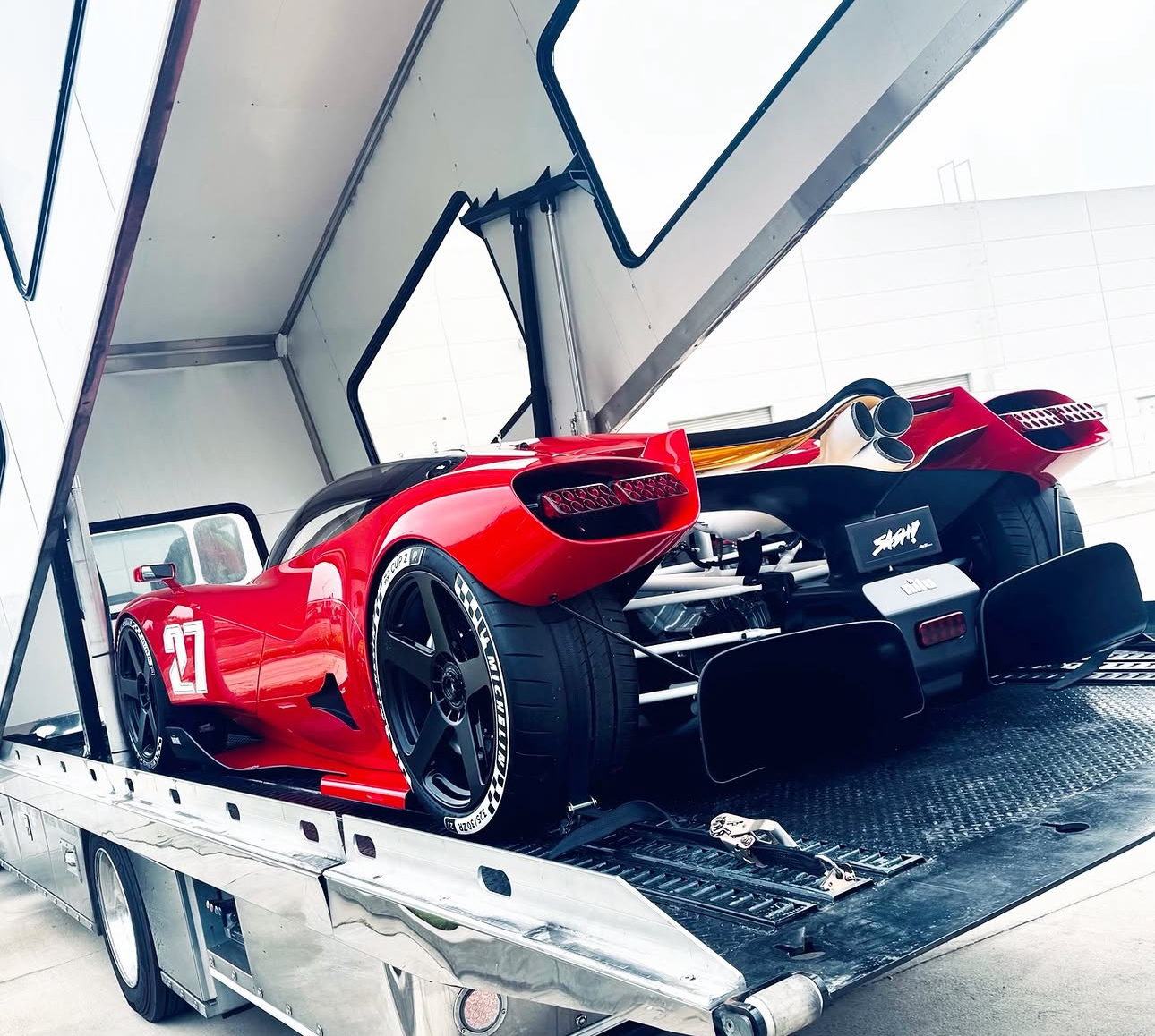 High-value performance vehicle being handled on specialist transporter